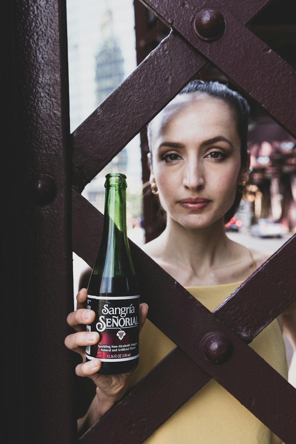 woman holding green glass bottle