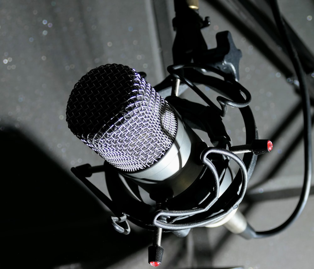 black and gray microphone on black and white textile