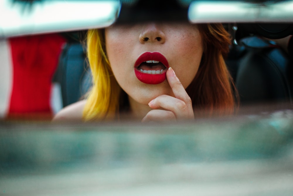 blonde haired girl in red lipstick