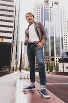 A man confidently dressed in business casual, standing tall in an urban setting.