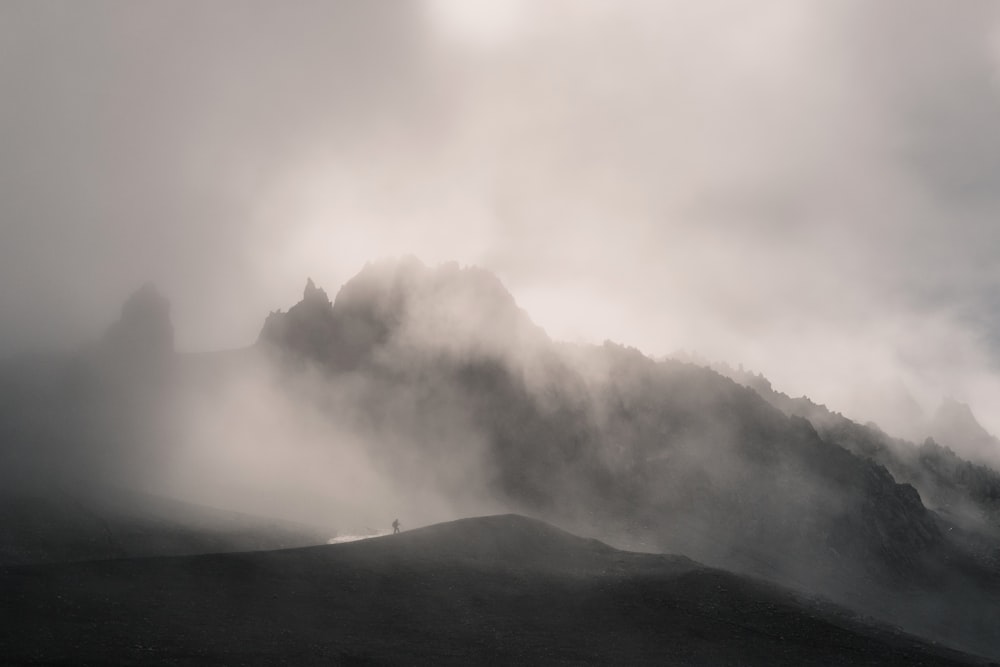 white clouds over green mountain