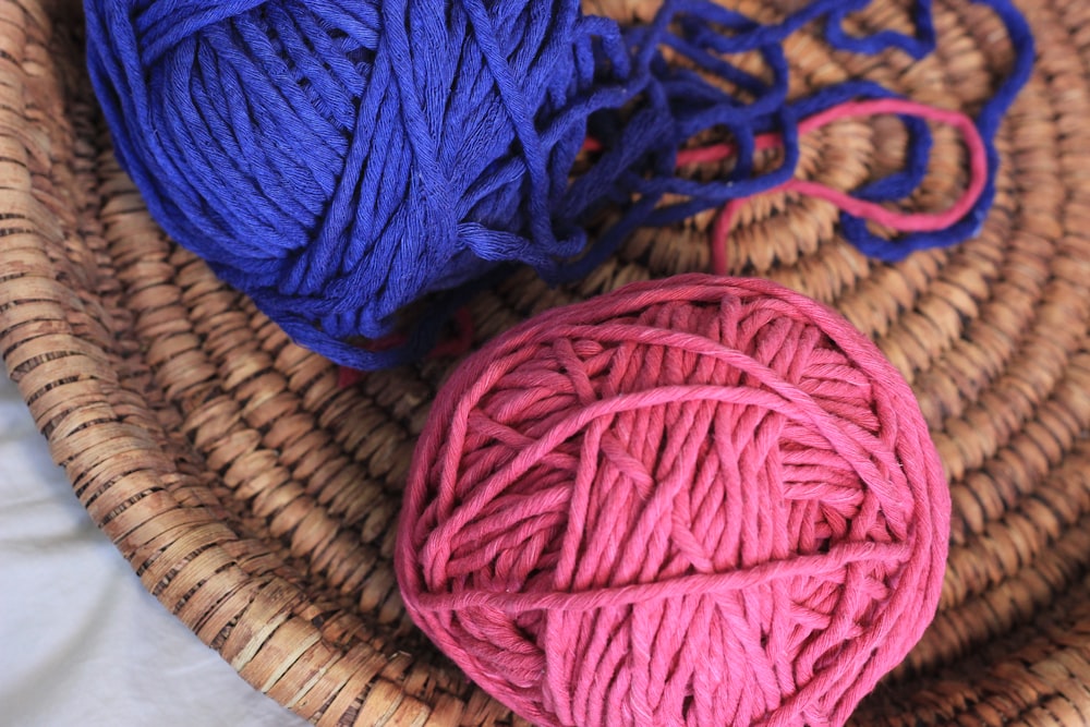 blue yarn on brown woven basket