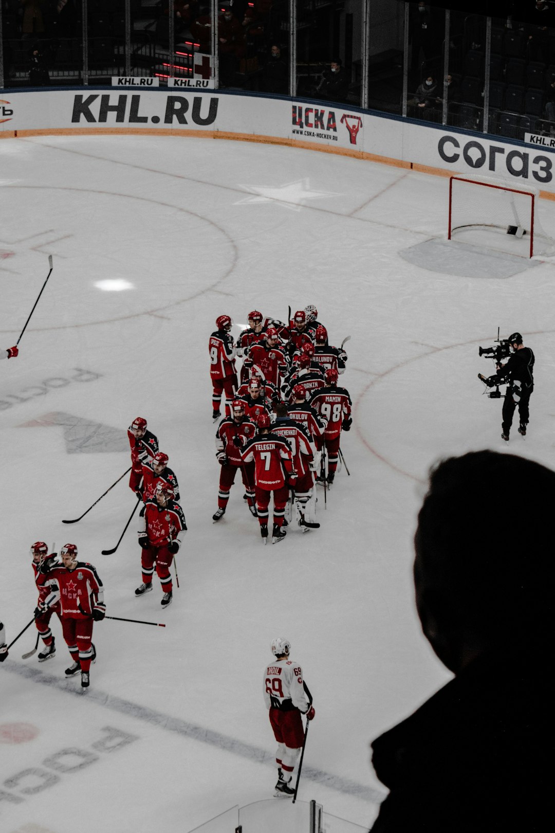 people in red and white ice hockey jersey playing ice hockey