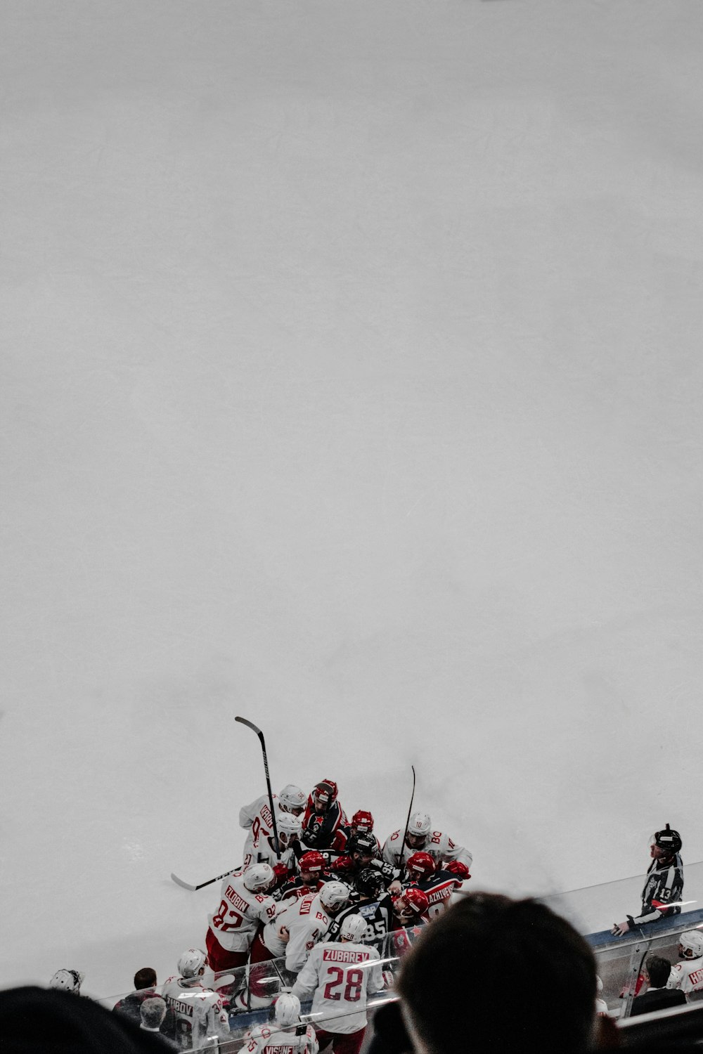 people in red suit riding on red ski lift