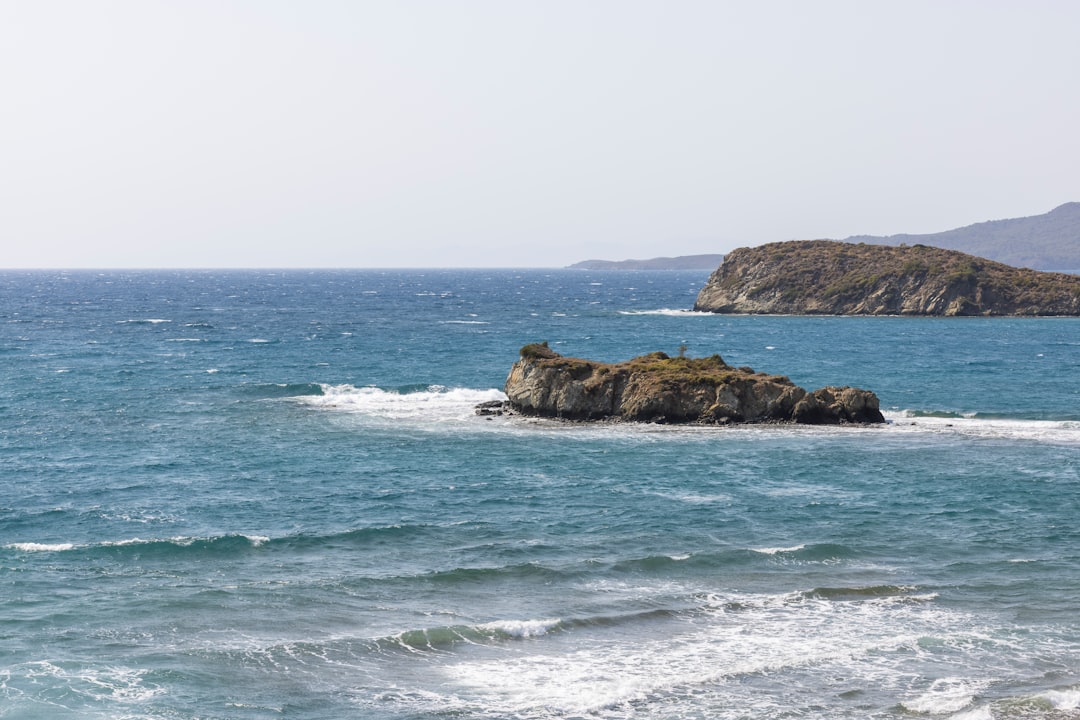 brown rock formation on sea during daytime