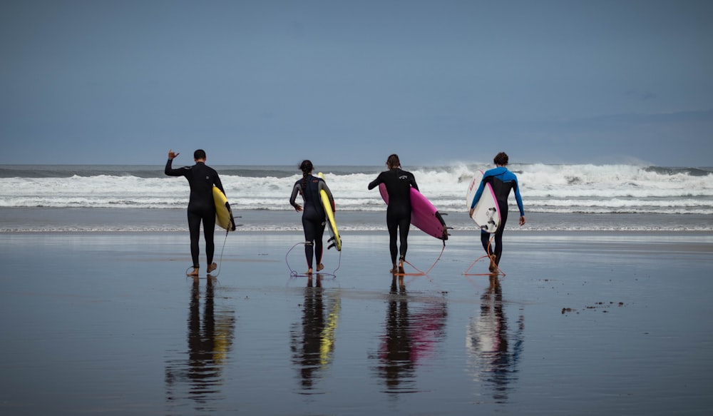 people in blue and yellow shirt and black pants running on water during daytime