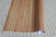 Rolls of eco-friendly wallpaper made from recycled materials, featuring natural patterns.