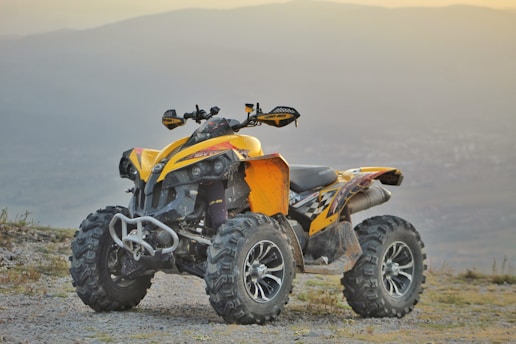 yellow and black atv on brown sand