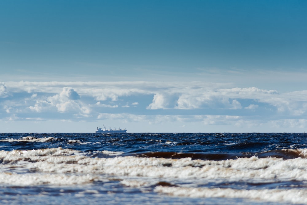 ocean waves under blue sky during daytime