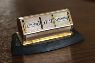 gold and silver box on brown wooden table