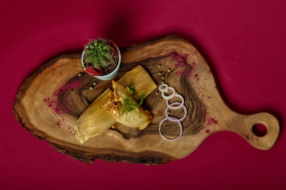 sliced meat with green vegetable on brown wooden plate