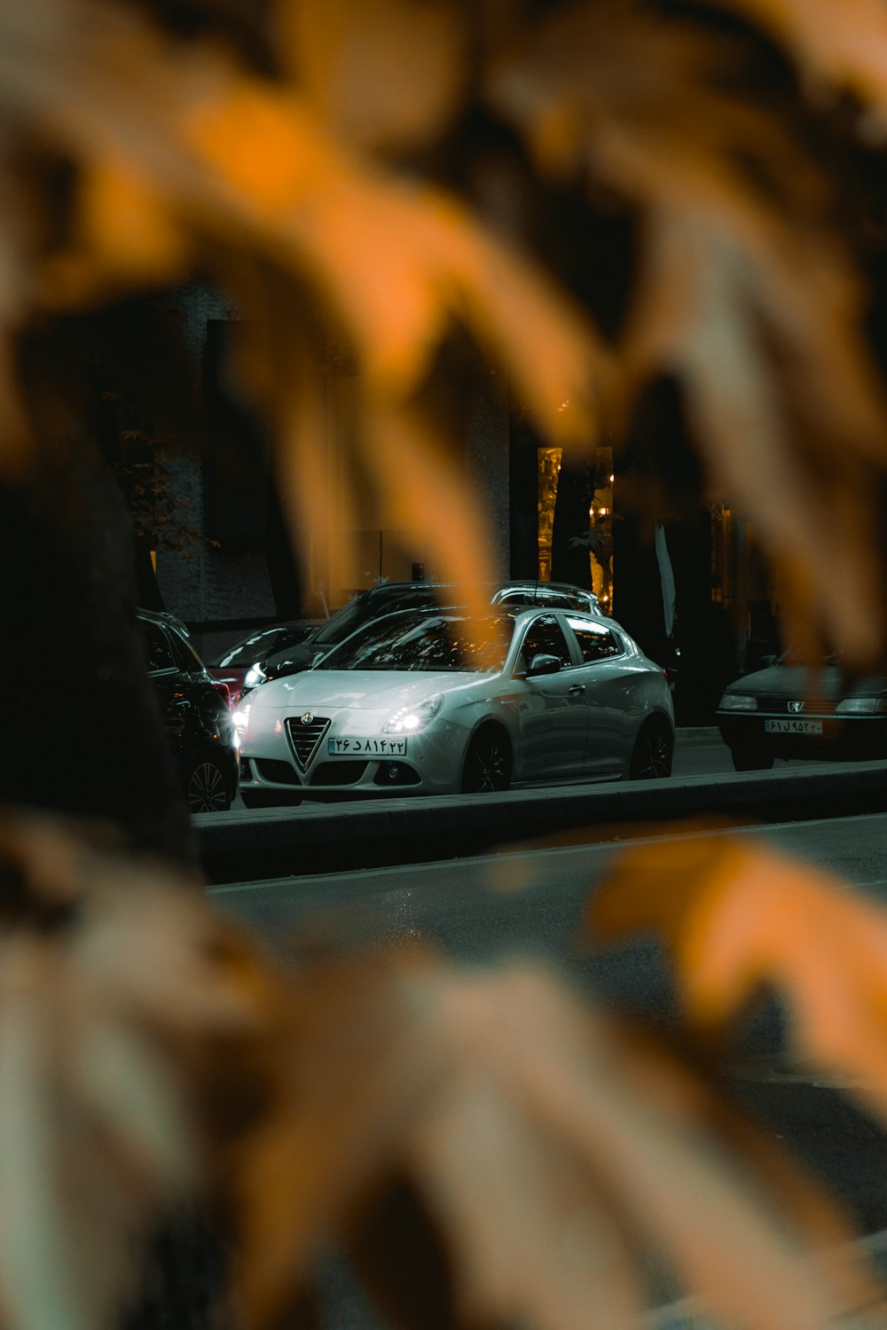 white car on road during night time