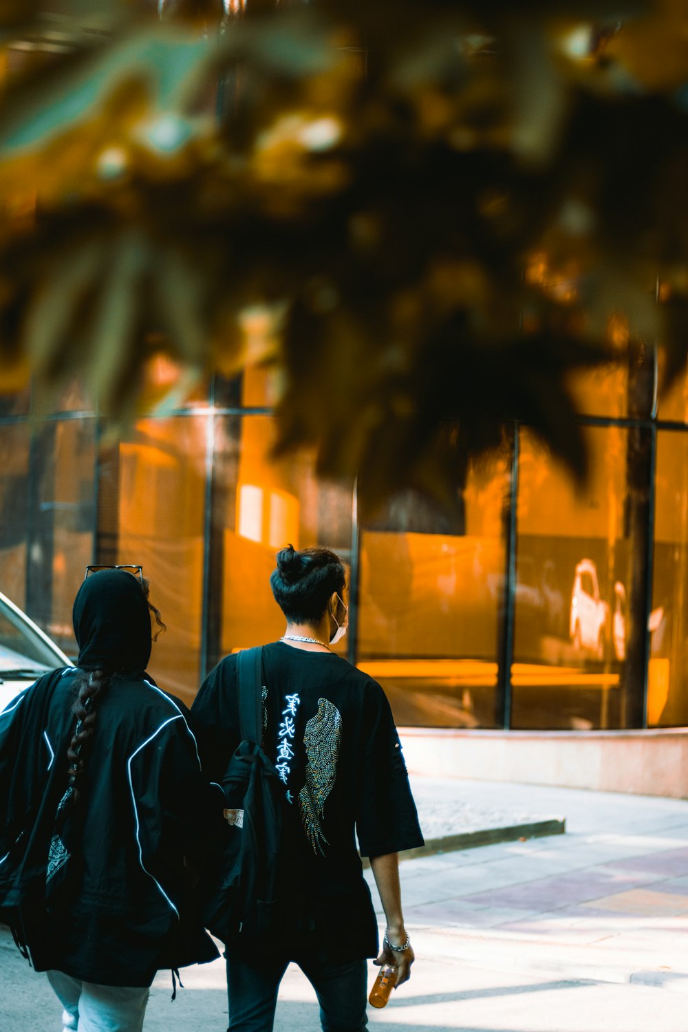 man in black jacket standing near road during daytime