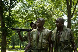 men in camouflage uniform holding rifle