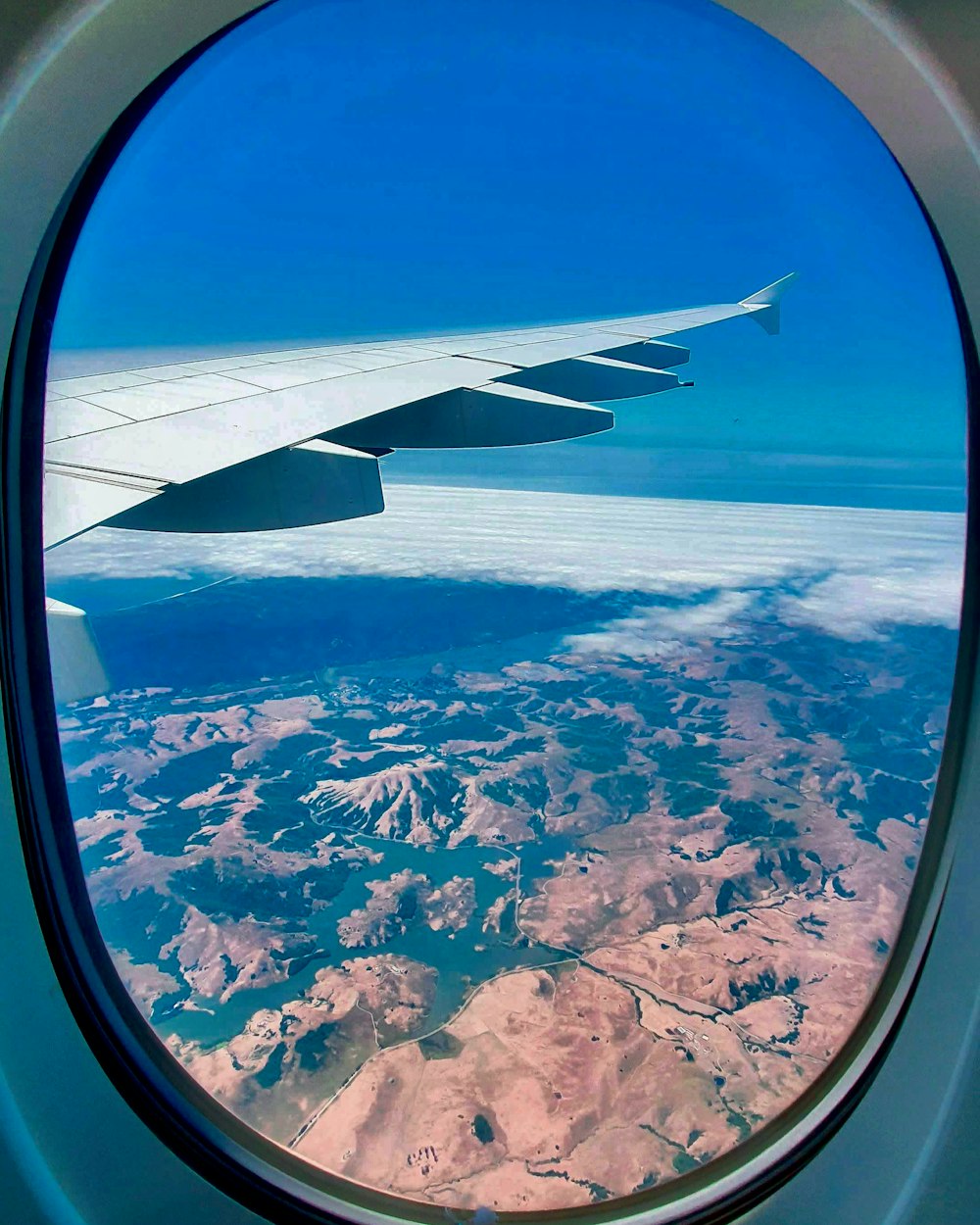 airplane window view of white clouds during daytime