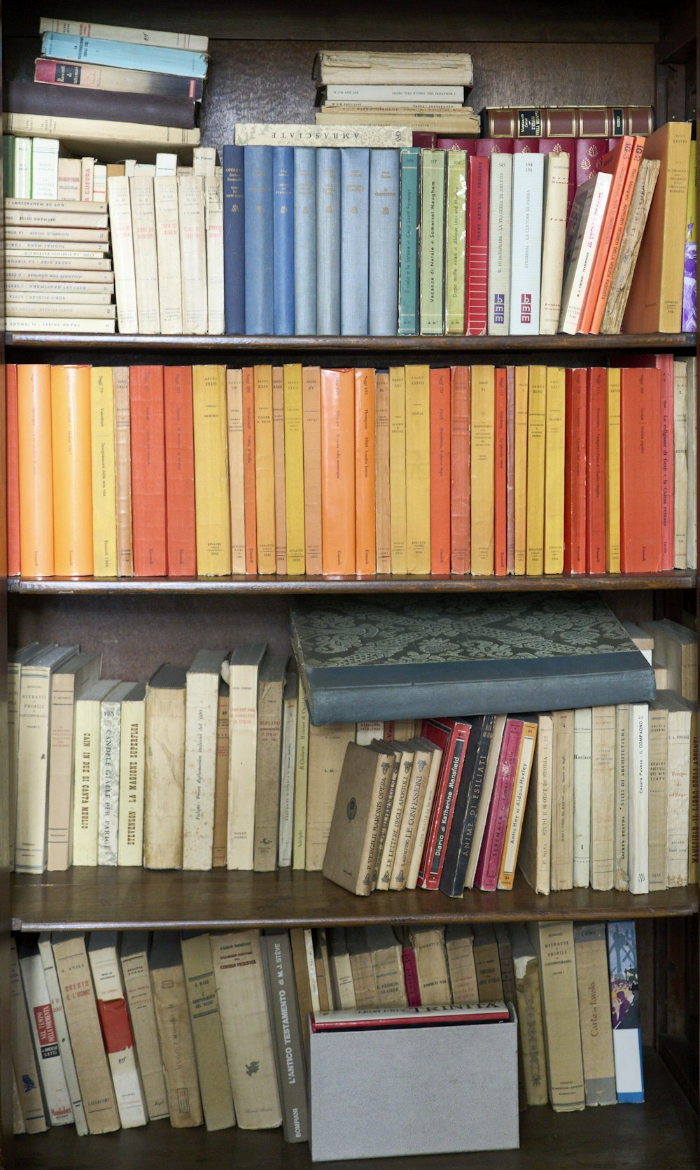 books on brown wooden shelf