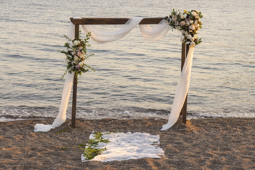 brown wooden stand on brown sand near body of water during daytime