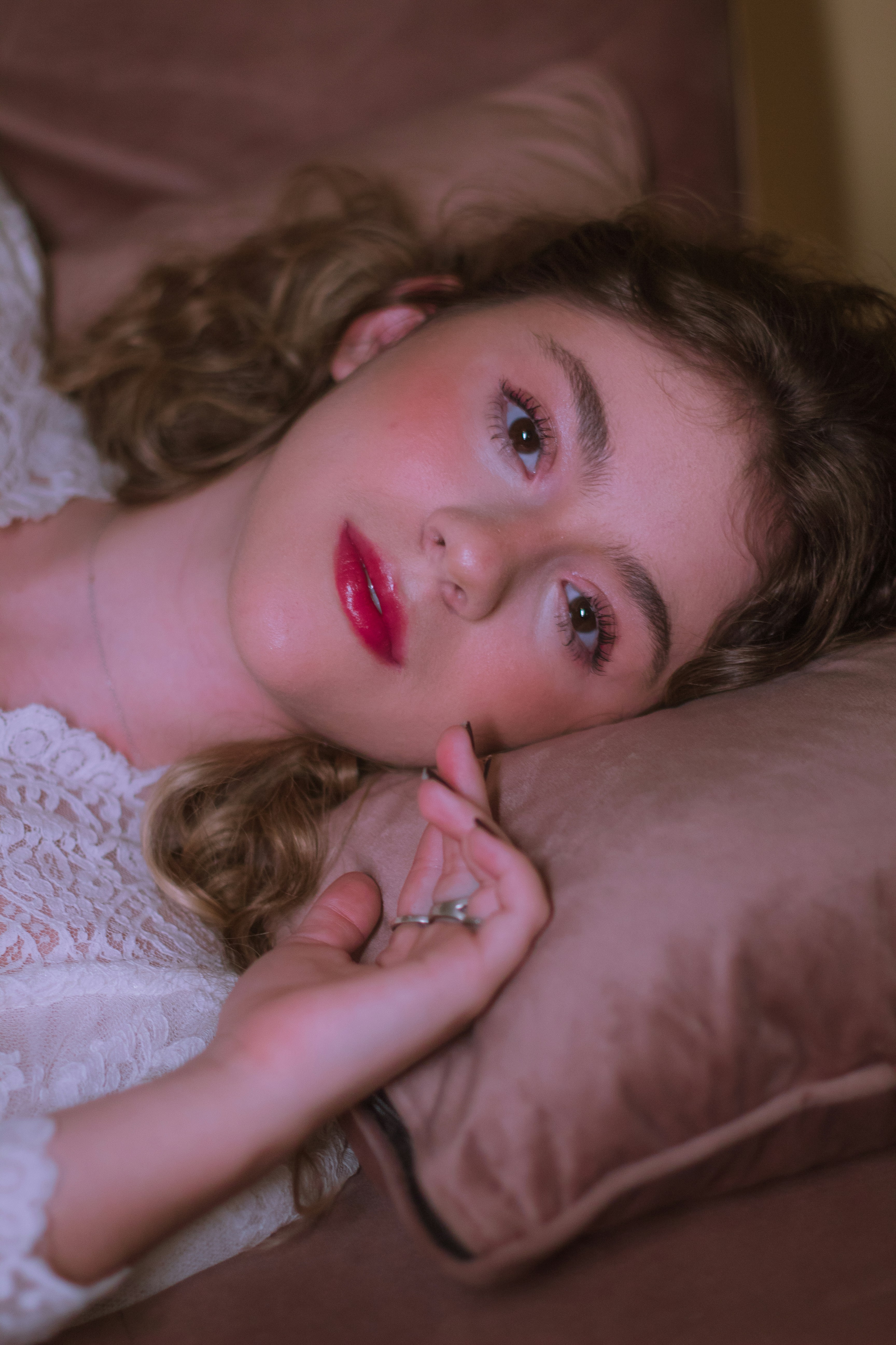woman lying on bed with red lipstick