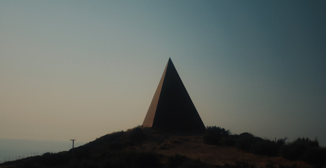 brown pyramid on top of hill