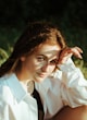 woman in white dress shirt wearing eyeglasses