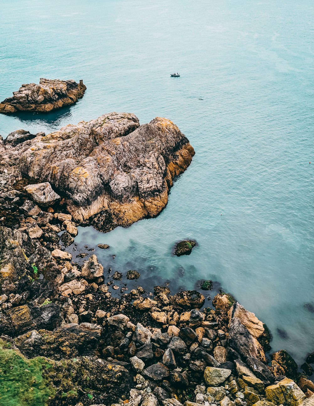 brown rock formation on sea during daytime