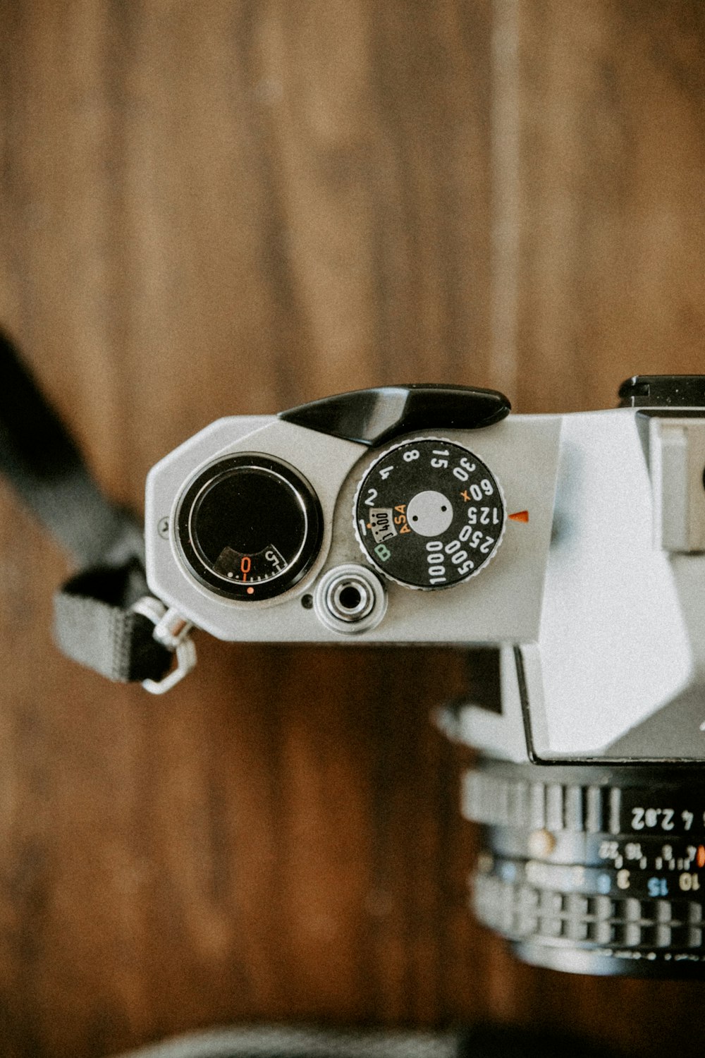 black and silver camera on brown wooden table