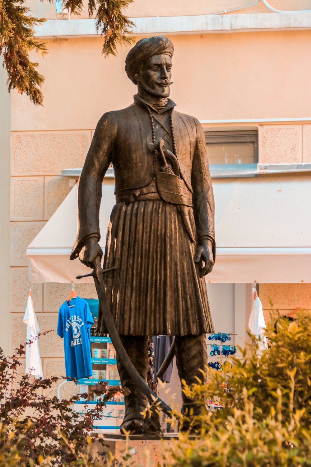 man holding a stick statue
