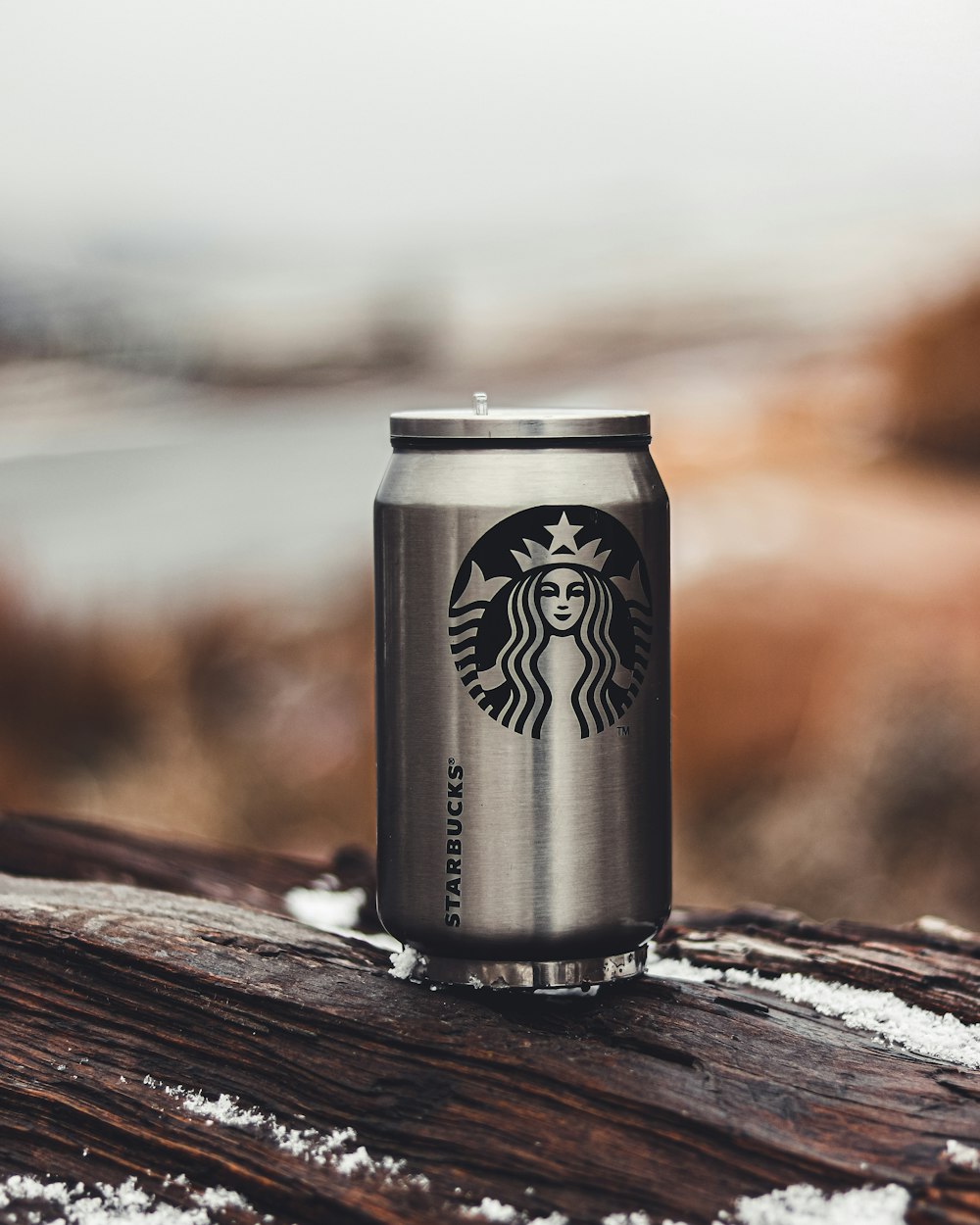 white and black can on brown wooden table