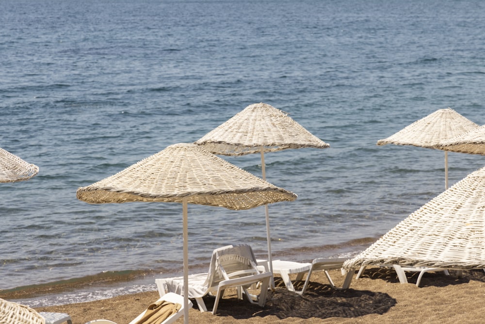 brown and white beach umbrellas on beach during daytime