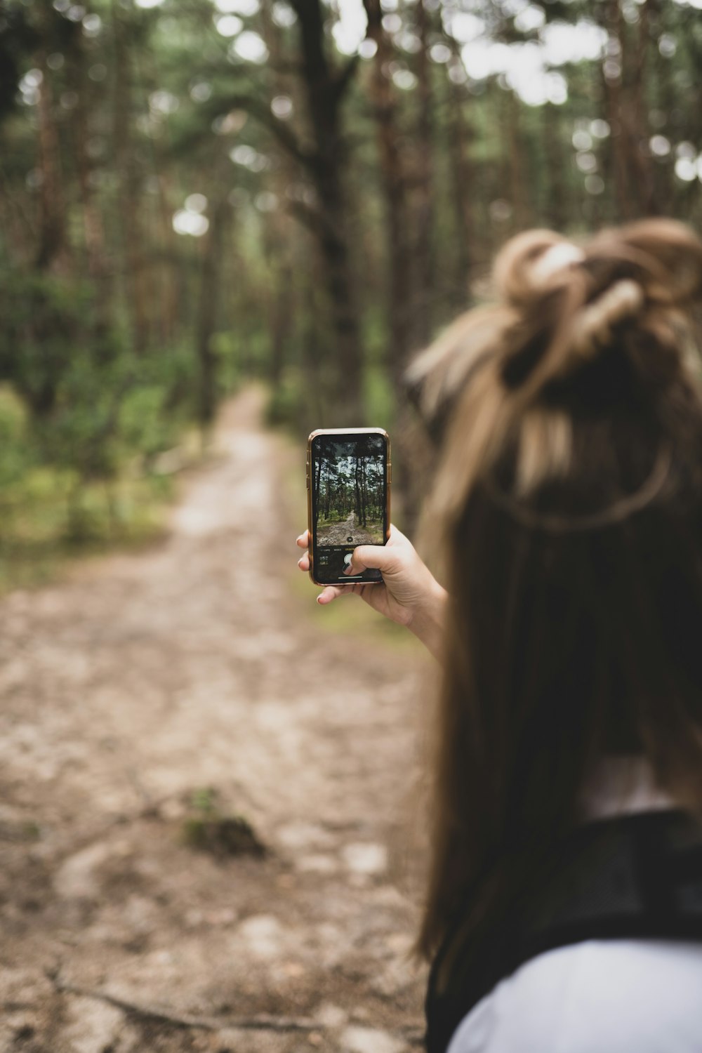 woman in black shirt holding black smartphone