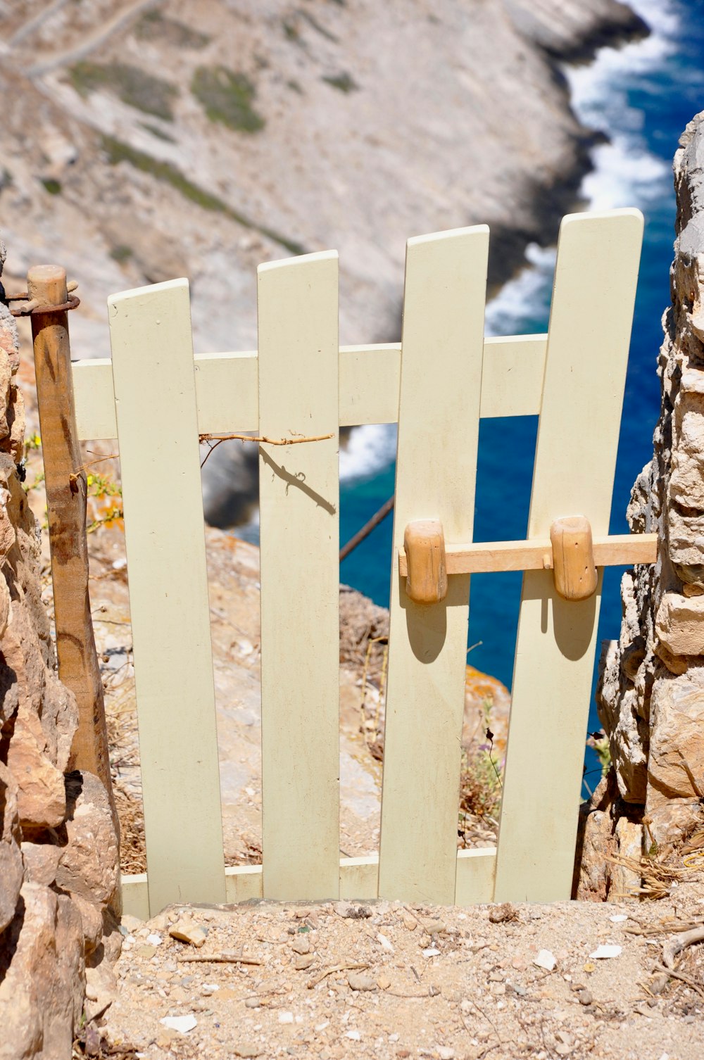 white wooden fence with blue metal chain