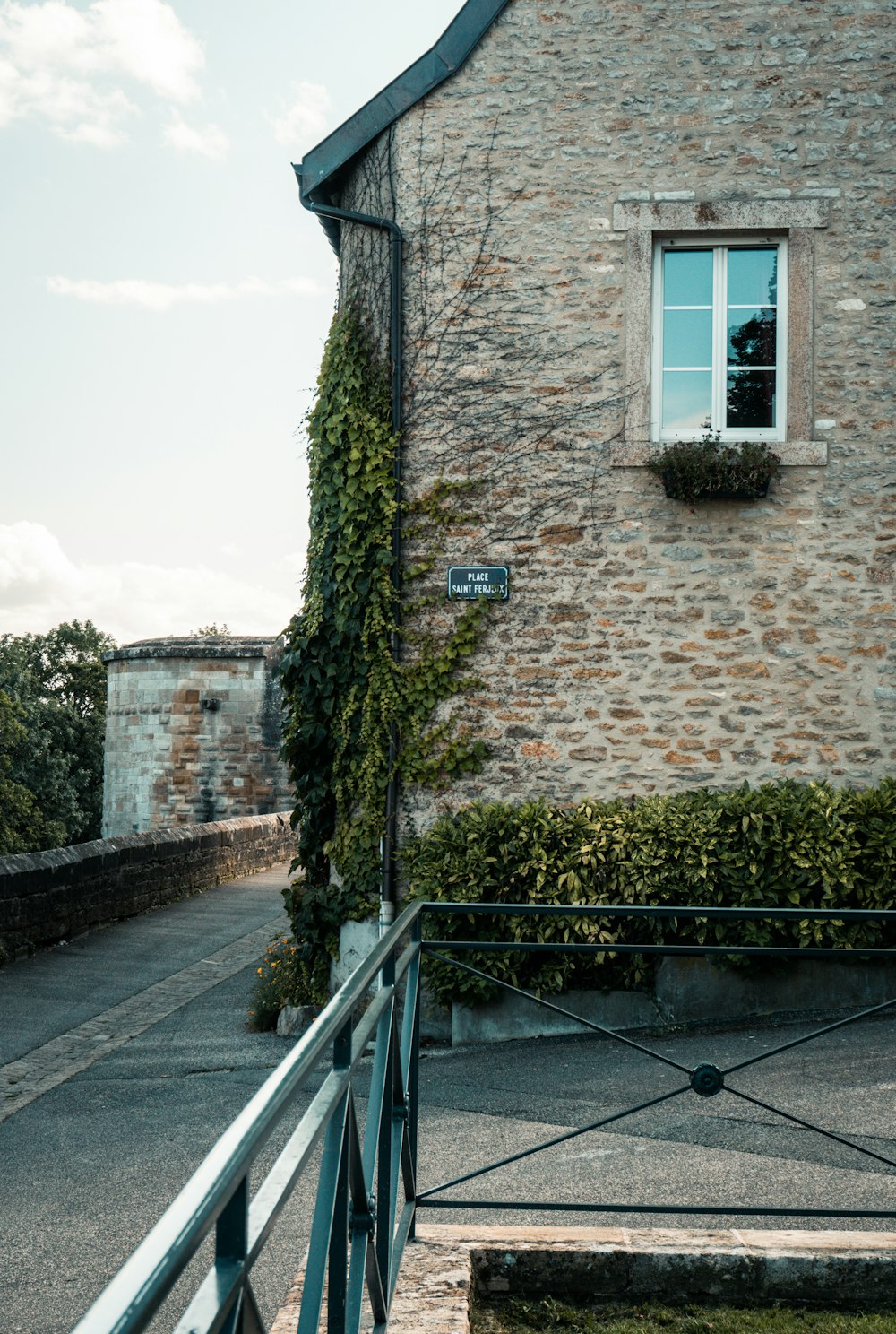 brown brick building with green moss on the wall