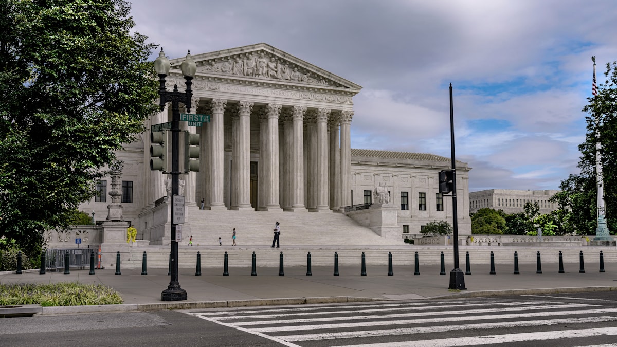 United States Supreme Court building with visitors walking on the steps
