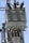 A close-up view of an electrical transformer mounted on a pole. The transformer has several insulators with spiral ridges arranged on top. Metal and ceramic components are part of the setup, and multiple wires are connected to the transformer. The clear blue sky is visible in the background.