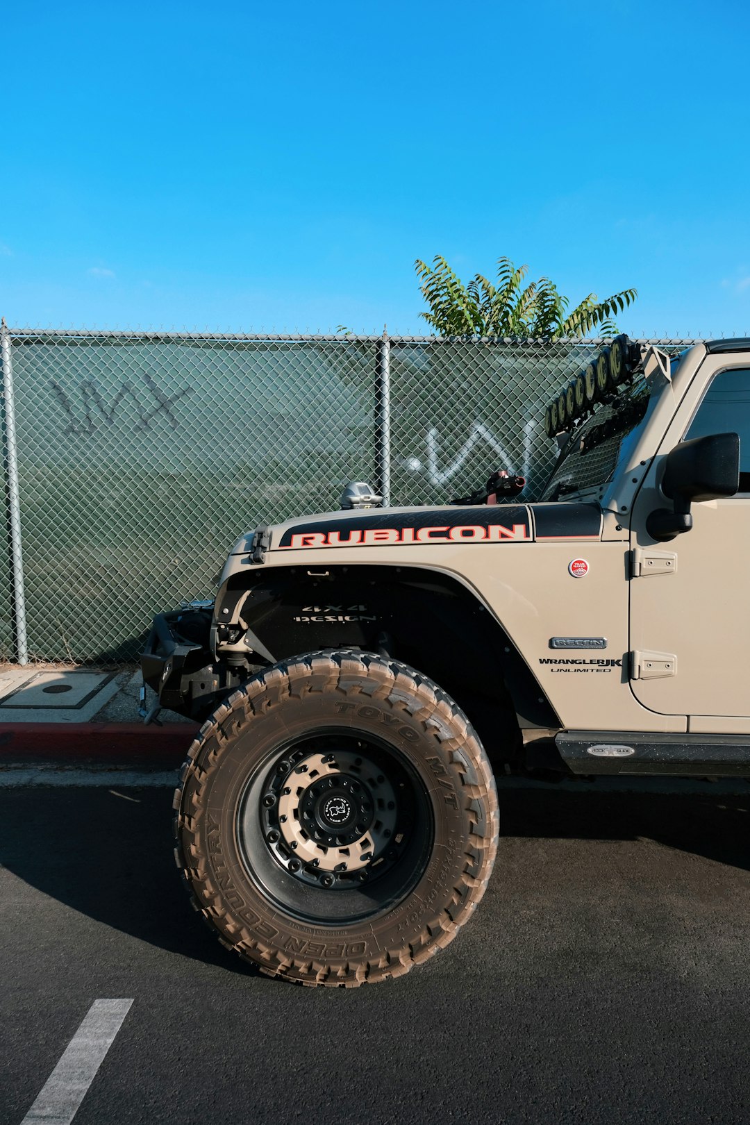 white and red truck parked near gray metal fence