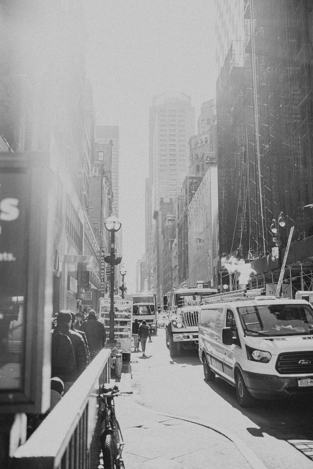 a black and white photo of a busy city street