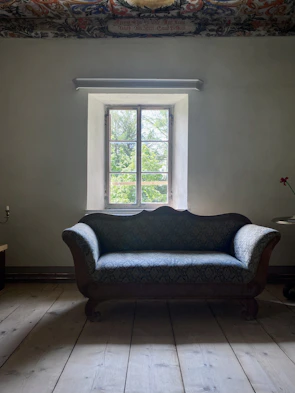 Before and after shots of a stained sofa transformed to look like new in a cozy Jaipur living room.