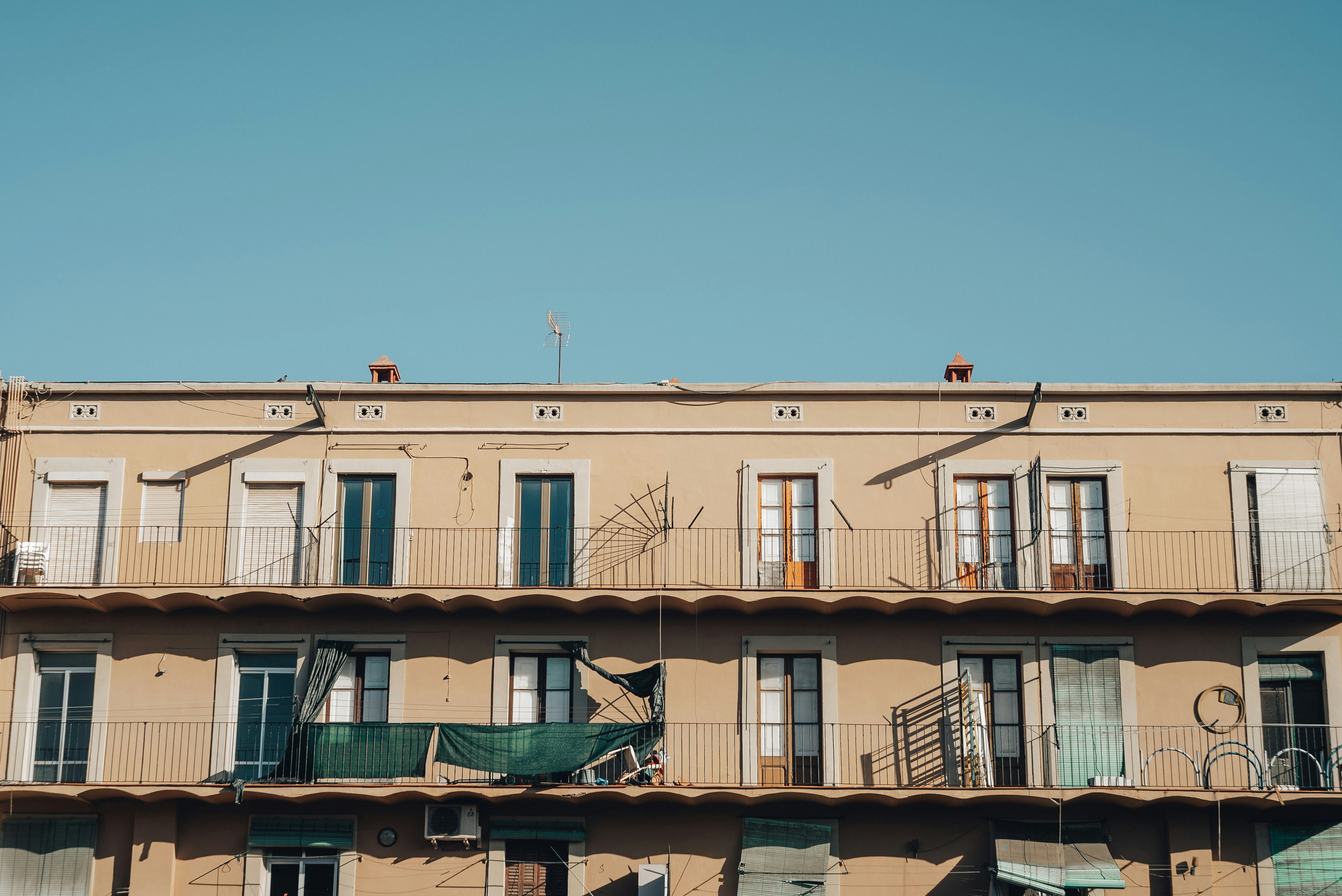 brown concrete building under blue sky during daytime, AirBnB Vibes