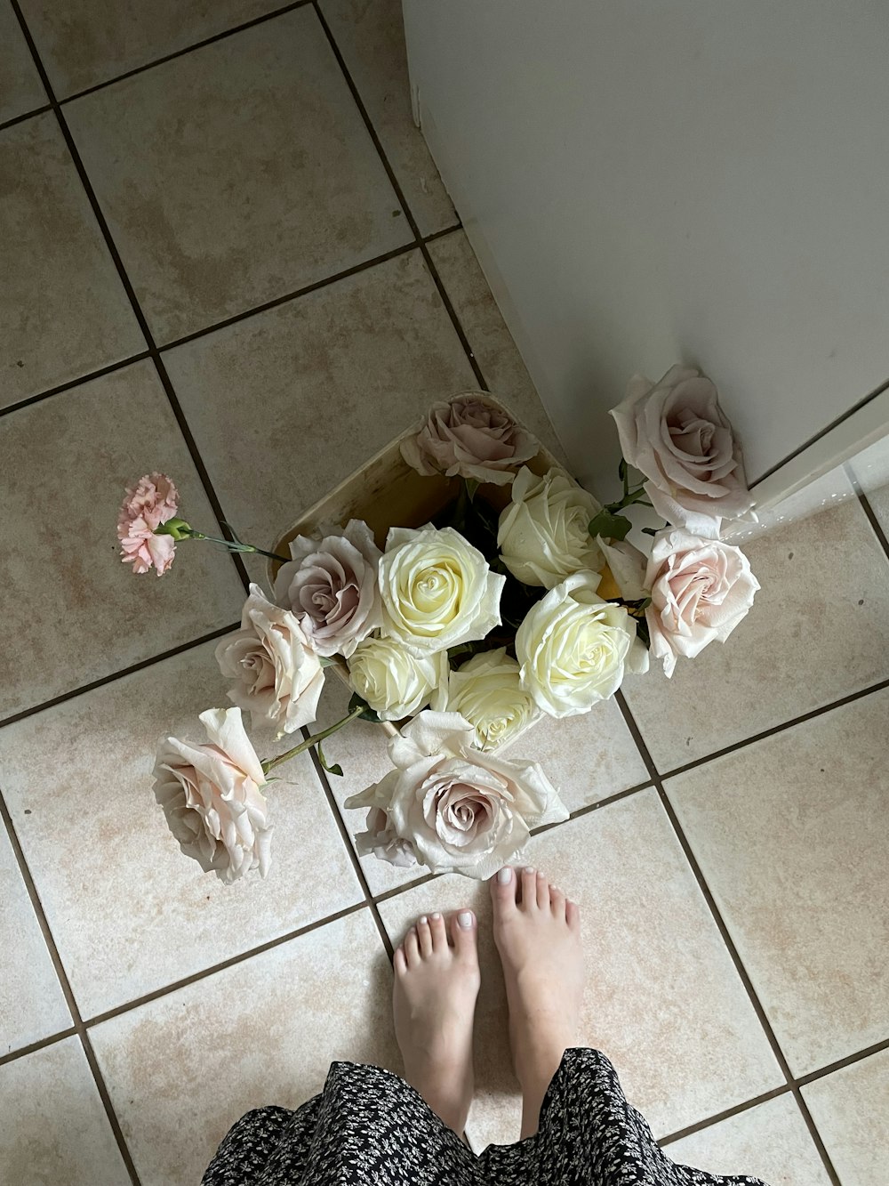 person standing on white ceramic floor tiles