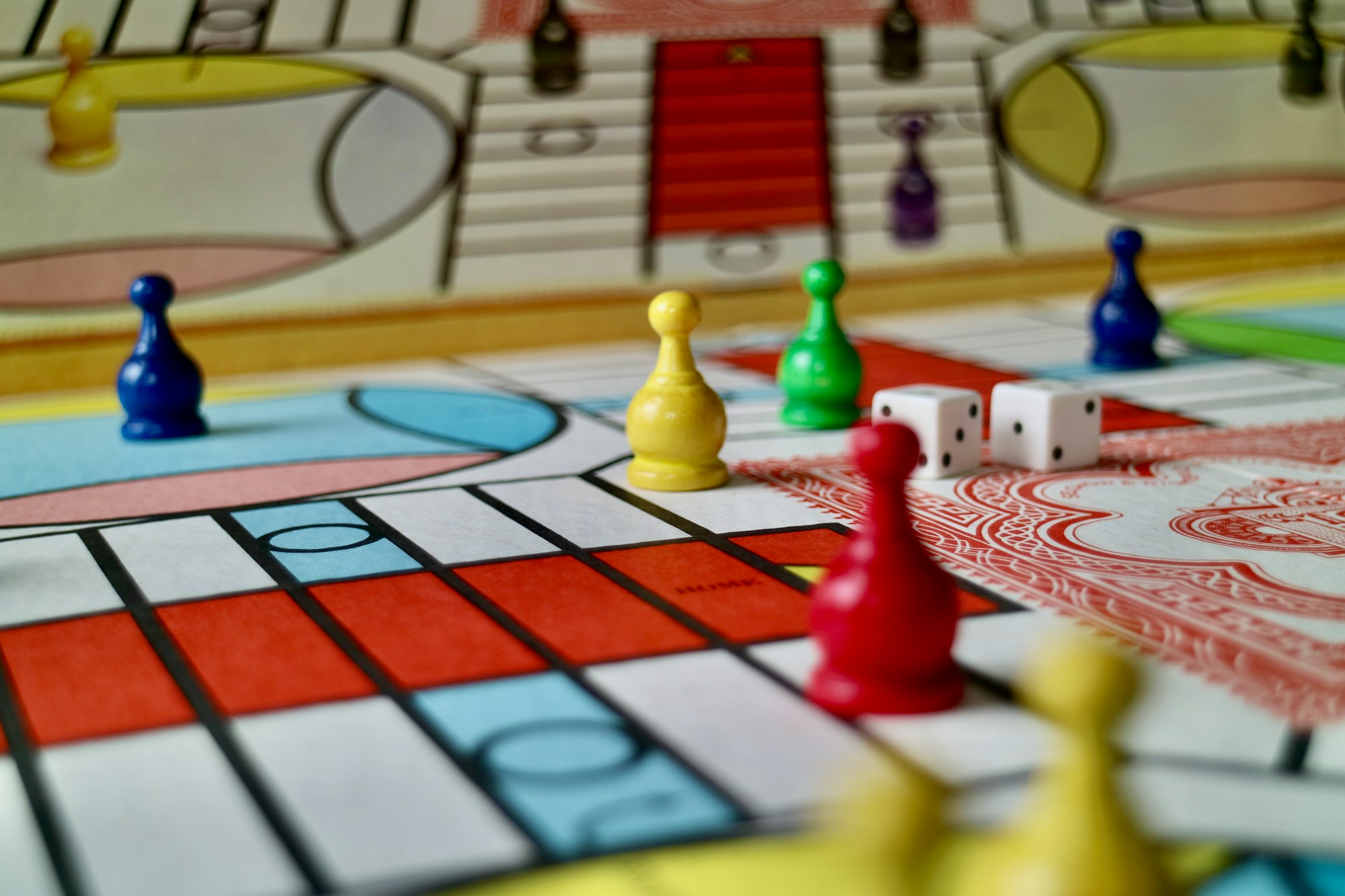 A game of parcheesi in progress featuring a vintage 1980s game set.