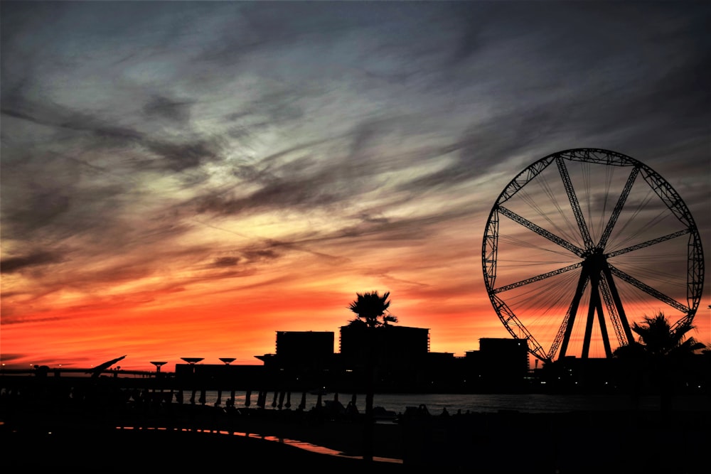 silhouette of ferris wheel during sunset