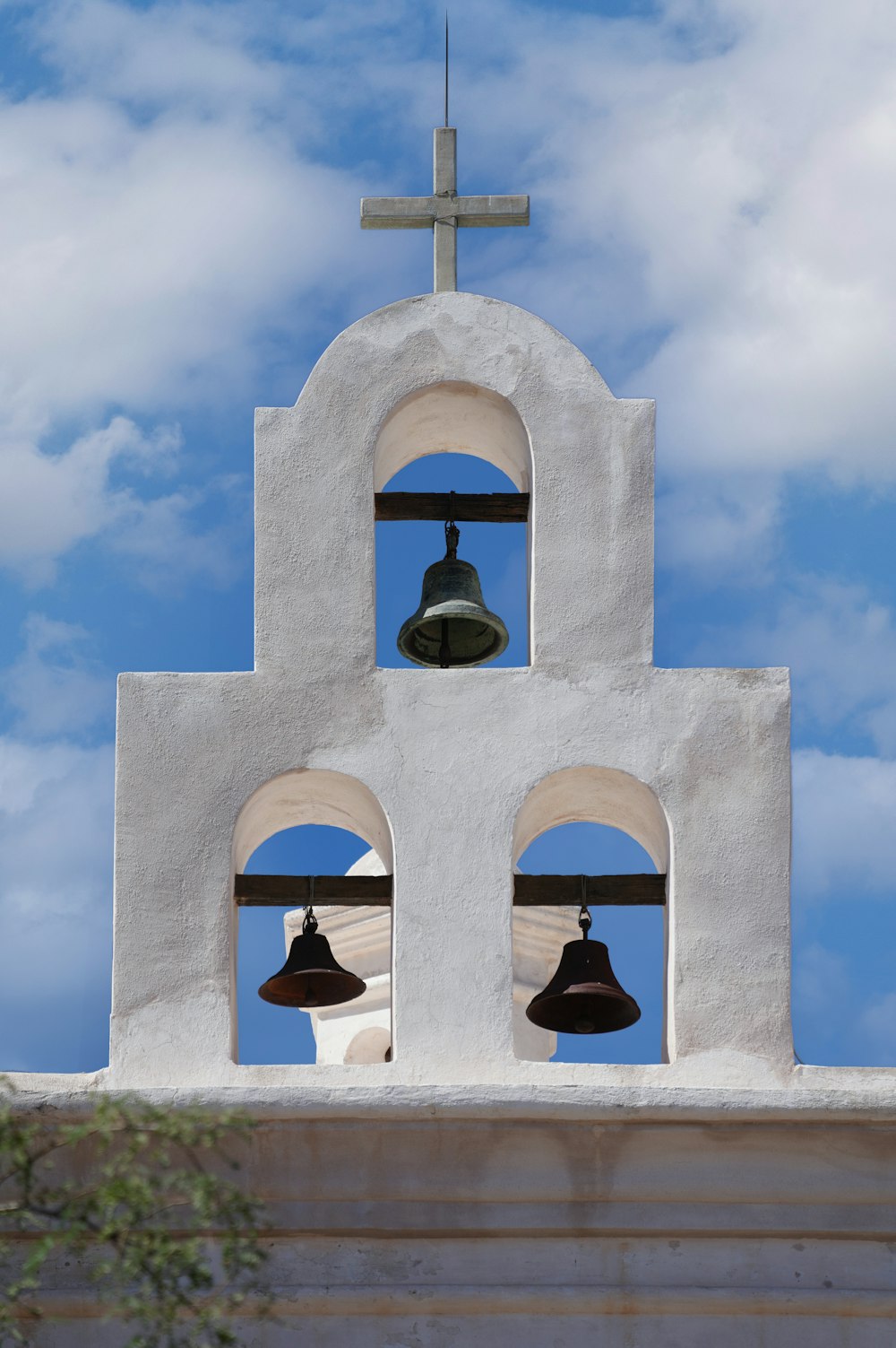 gray concrete bell under blue sky during daytime