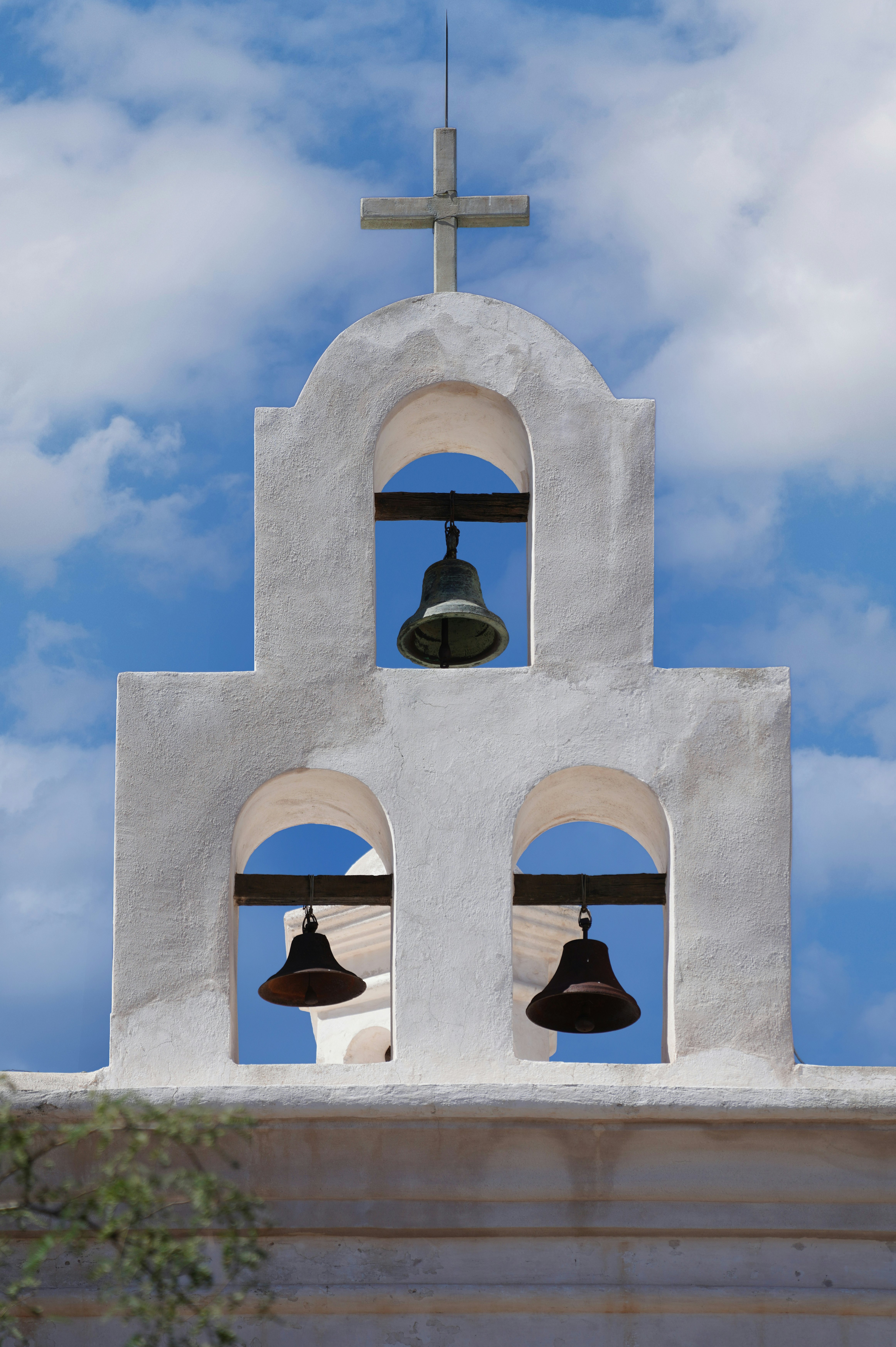 gray concrete bell under blue sky during daytime