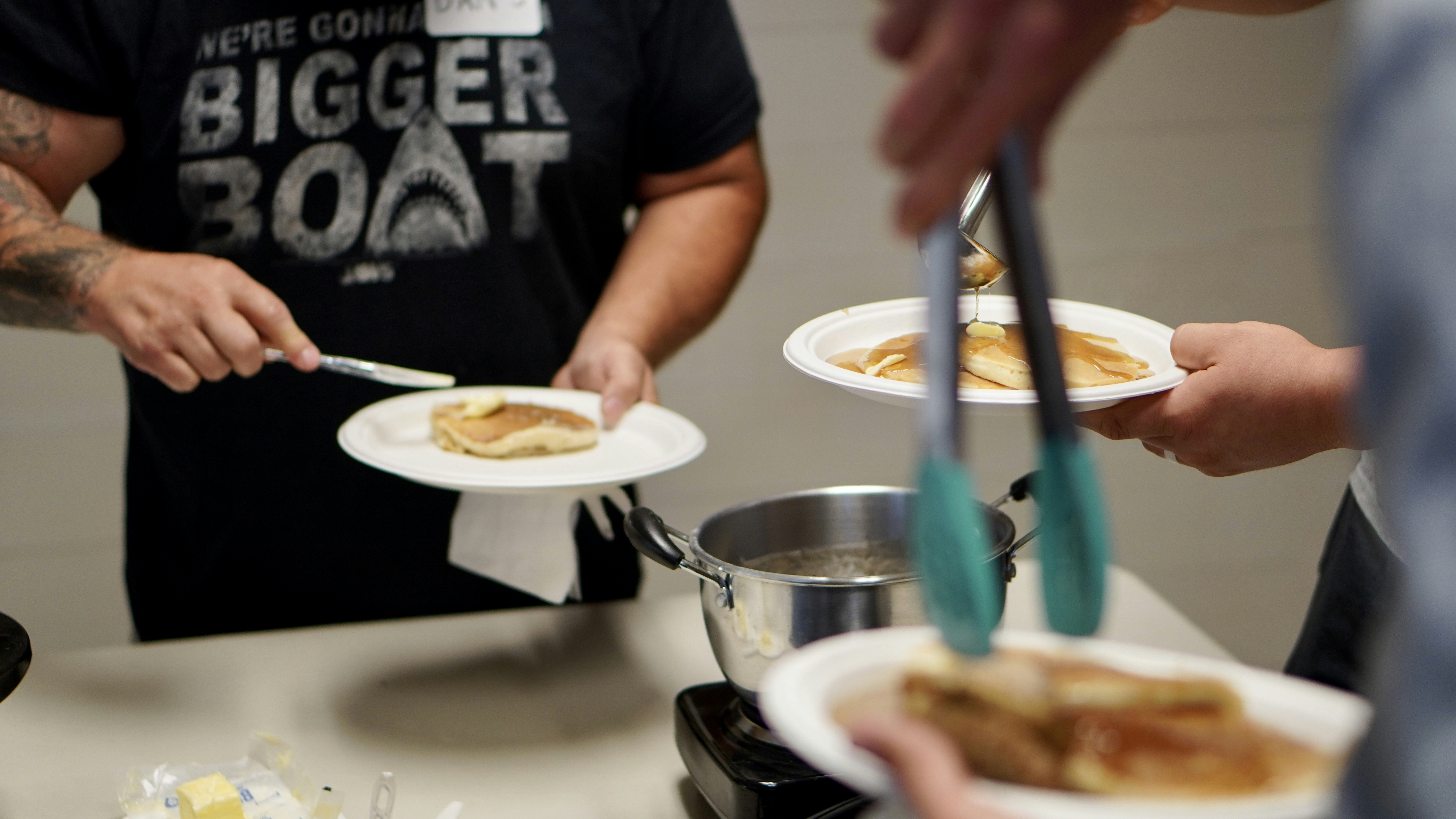 person holding stainless steel spoon and fork