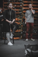 Consultant guiding a young singer during a media interview setup.