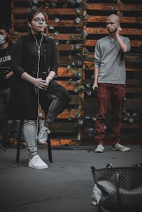 Consultant guiding a young singer during a media interview setup.