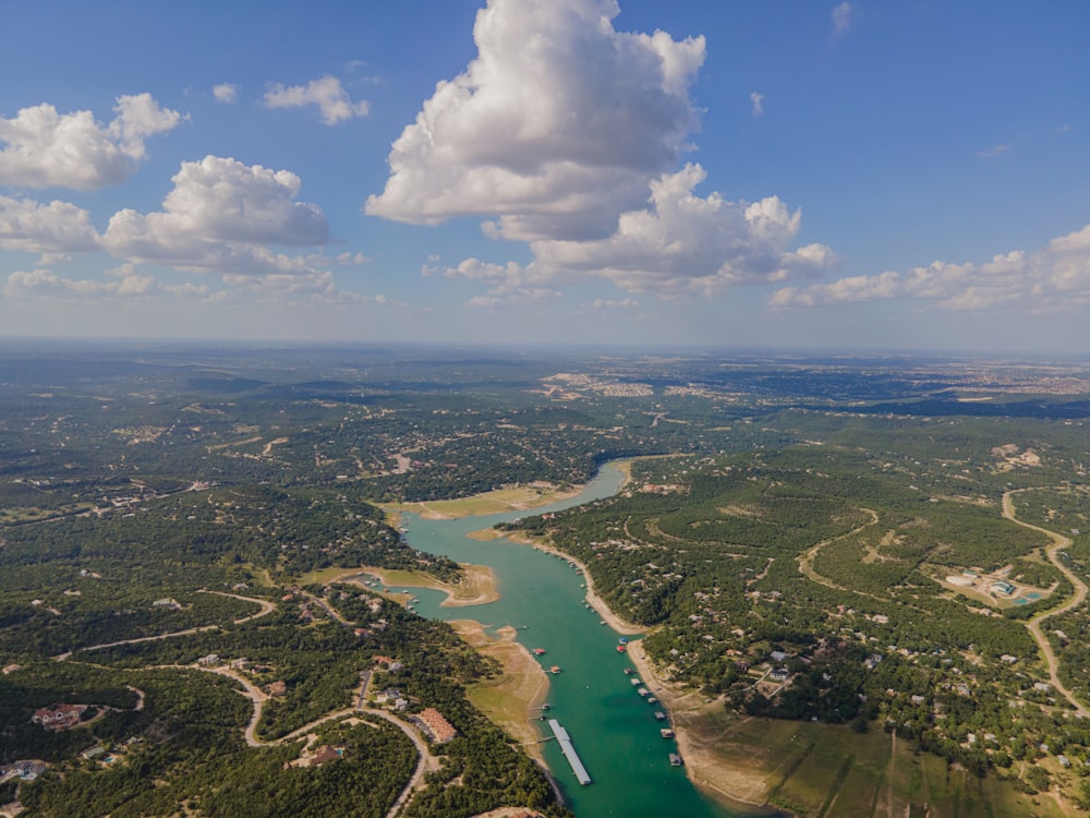 aerial view of green field and body of water during daytime