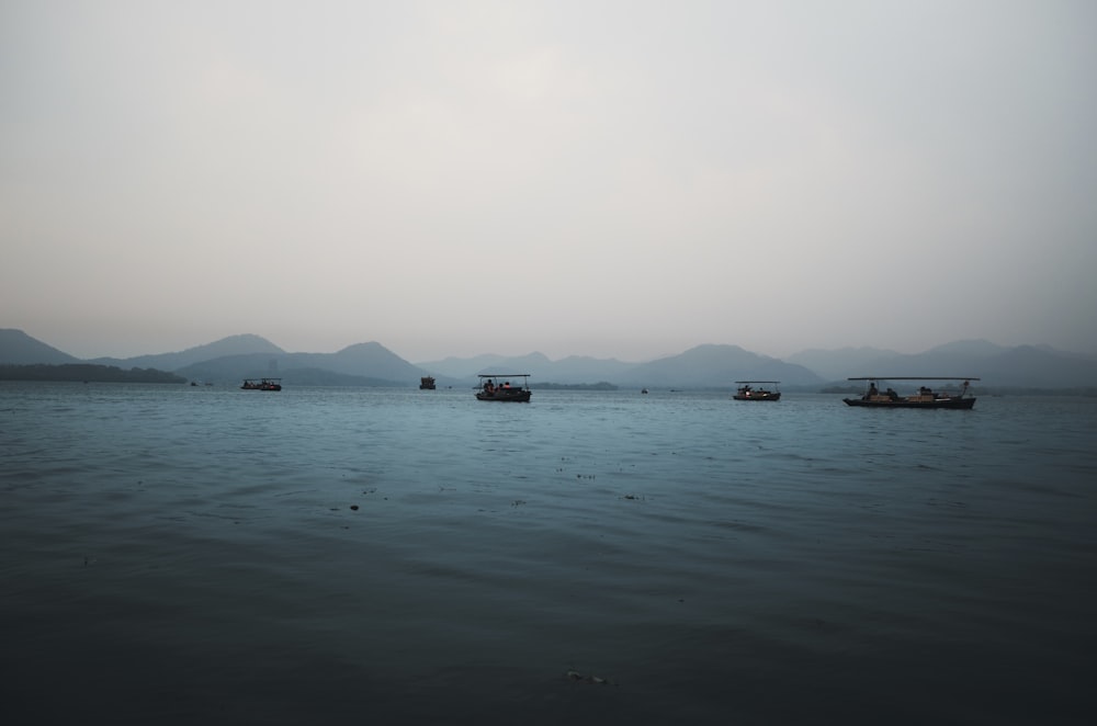 boat on sea under white sky during daytime