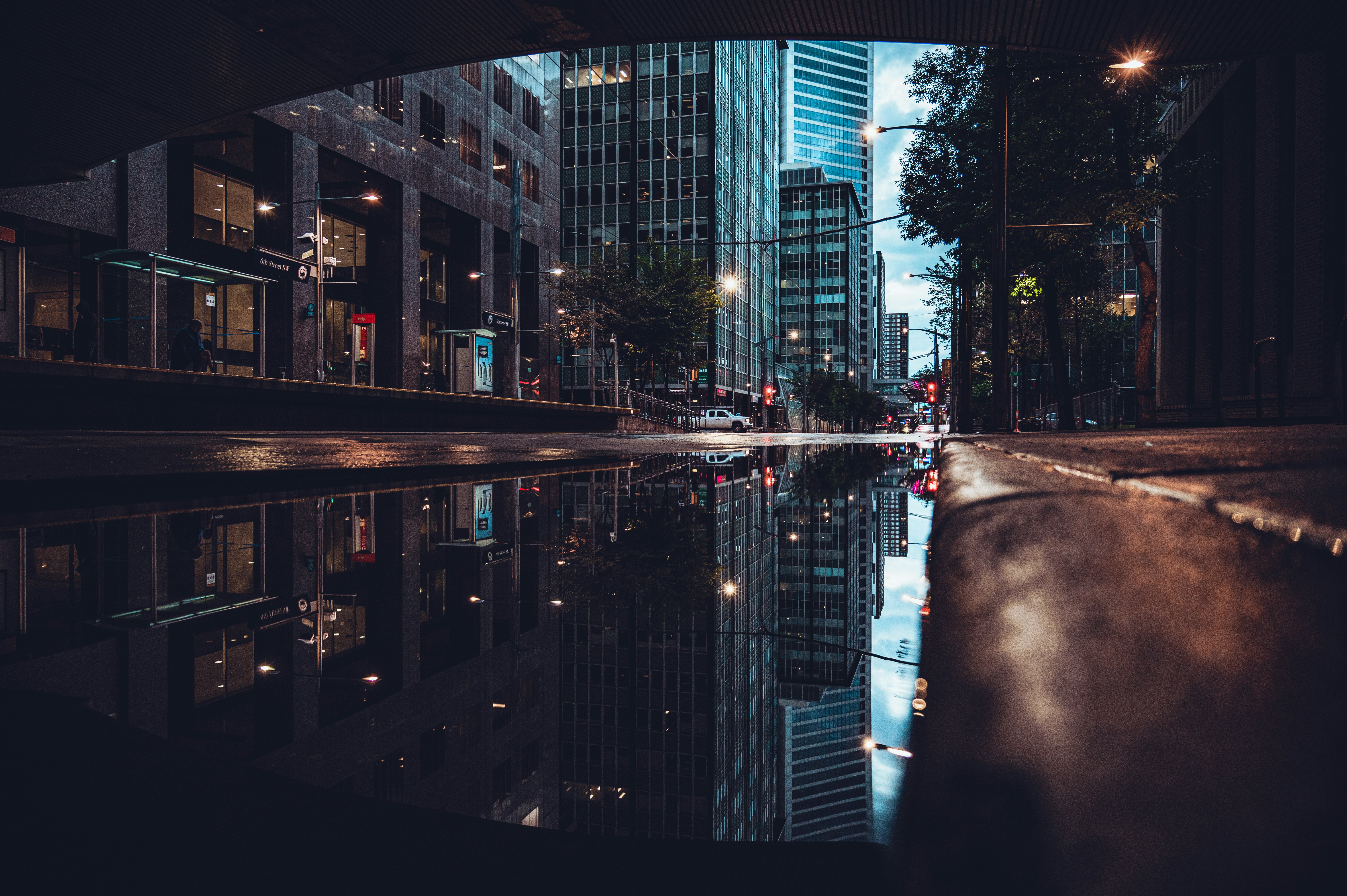 city buildings near body of water during night time