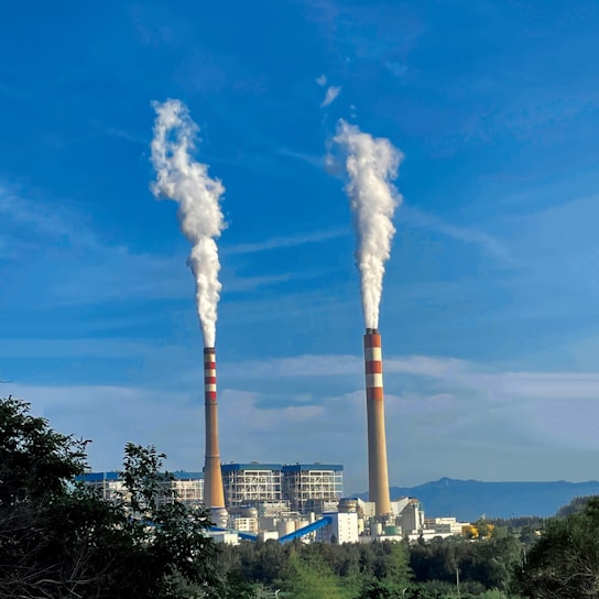 A factory with smoke stacks emitting clean air.